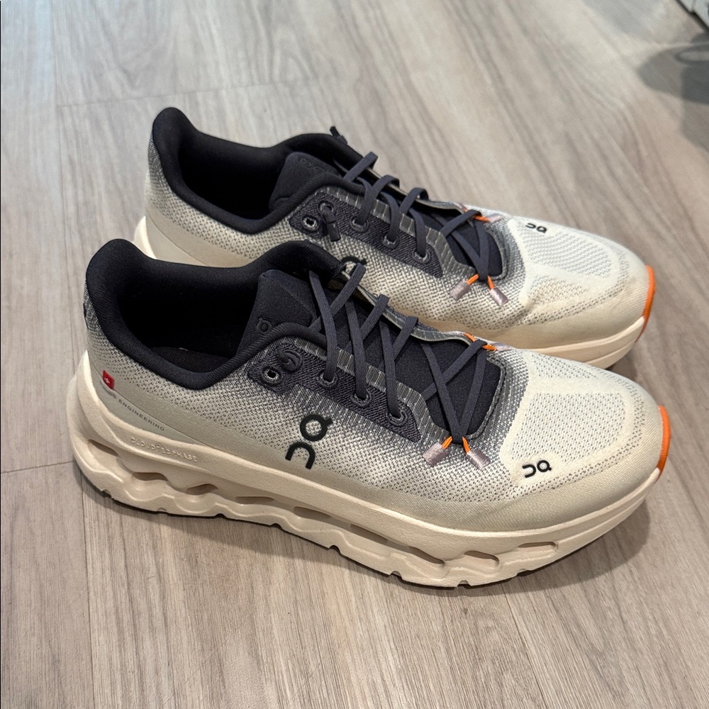 On Running Gray and Black Sneakers with Orange Accents